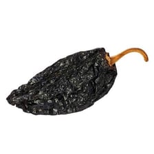 A dark, wrinkled dried ancho pepper.