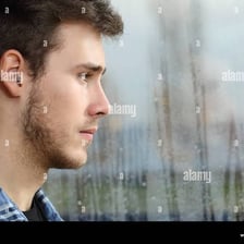 A person gazing wistfully out a window