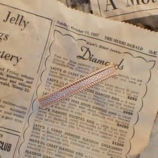 A bangle bracelet beside a reporter’s notes