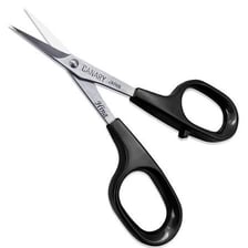 Small scissors cutting a short piece from a sheet of paper.