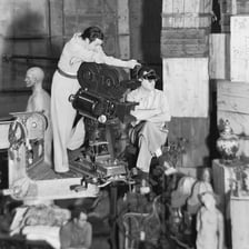 A film director overseeing actors and crew during a scene.
