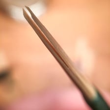 An oboe with its double reed visible
