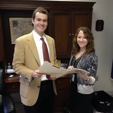 An aide speaking with or assisting a public official