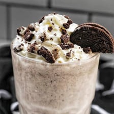 A milkshake blended with chocolate sandwich cookies and topped with whipped cream.