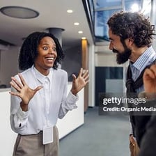 A person reacting with surprise in conversation.