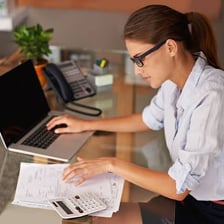A person submitting tax documents electronically on a laptop.
