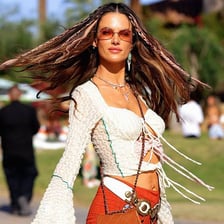 A festivalgoer wearing bohemian-style clothing at an outdoor music festival