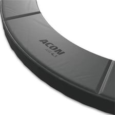 Protective padded surfaces around trampolines in an indoor trampoline park