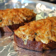 A tuna melt sandwich with tuna filling and melted cheese.