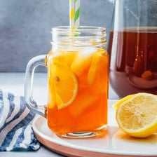 A glass of iced tea garnished with lemon.