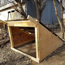 A small farm enclosure used to house pigs.