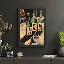 A sake bottle and glass beside old photographs