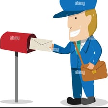 A postal worker placing a letter into a mailbox.