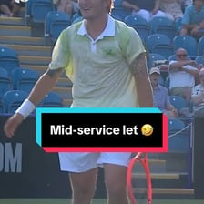 A tennis ball touching the net during a serve.