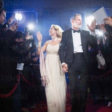 A celebrity couple appearing together on a red carpet.