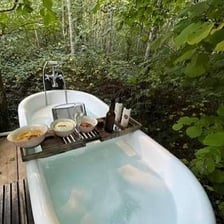 An outdoor hot tub filled with bubbling water