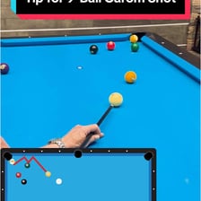 A billiards shot showing a cue ball rebounding off another ball.