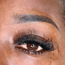 A close-up of a naturally arched eyebrow.