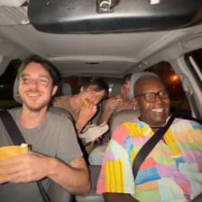 Friends inviting another person to come along in a car