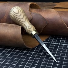 A pointed handheld awl used for piercing material.