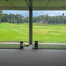 A golfer preparing to tee off on a links-style course