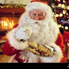 Santa Claus beside a plate of Christmas cookies.