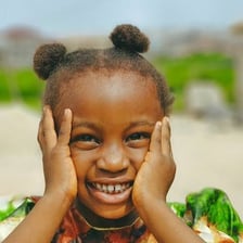 A smiling person enjoying a bright, cheerful day