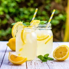 A glass of lemonade garnished with citrus