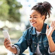 A person waving hello to someone far away