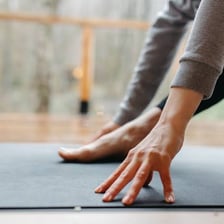 A person practicing yoga on a mat.