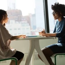 Two people talking as one forms an impression of the other.