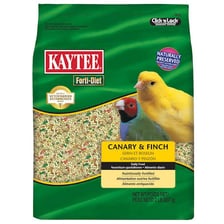 A yellow canary eating seeds from a feeder.