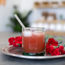 A drinking straw rests in a glass of beverage.