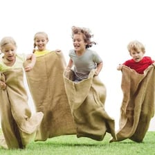 People participating in a sack race outdoors