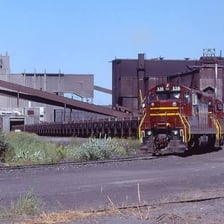 Rail cars loaded with mined ore.