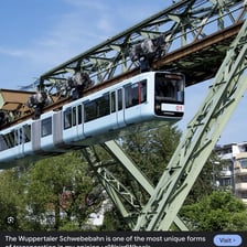 An elevated urban train traveling above a city street.