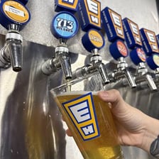Draft beer being poured from a tap into a glass