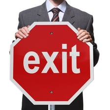 A person gesturing for someone to leave through an exit.