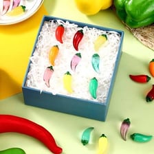 A collection of colorful chili peppers displayed at a food gathering.