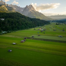 A broad green valley between hills