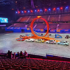 A stunt performance taking place in a large arena.