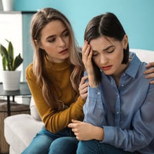A person visibly showing concern and care for another person.
