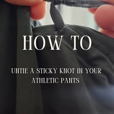 Hands loosening a tightly tied knot.