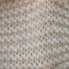 Close-up of knitted fabric showing knit and purl stitches.