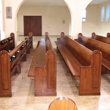 Rows of wooden pews inside a church