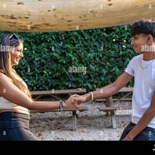 Two people greeting each other casually.