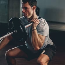 A person wearing a T-shirt during a gym workout