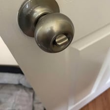 An open, unlocked door leading into a room.