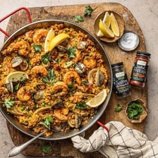 A saffron-colored paella served in a wide pan