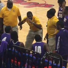 Coach speaking encouragingly to a team